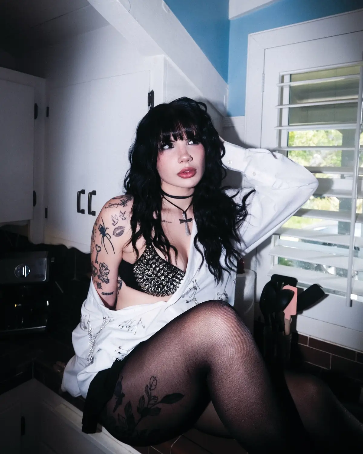 Bailey Spinn tattoos: Genuine Inked editorial portrait showing Spinn's arm, hand and leg tattoos.