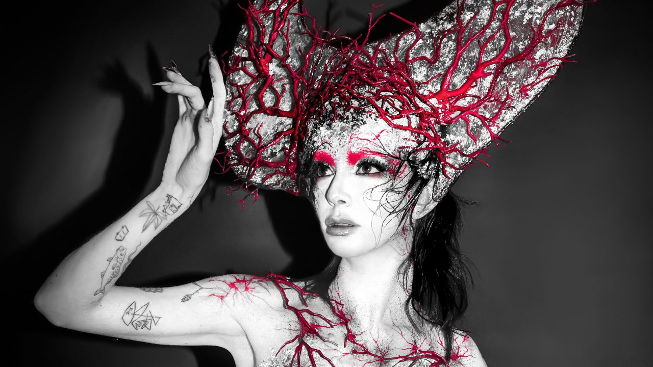 Bambie Thug tattoos: wide portrait showing visible arm tattoos including doodle and botanical motifs