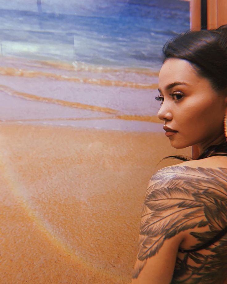 Bella Poarch tattoos: feather arm tattoo and collection overview