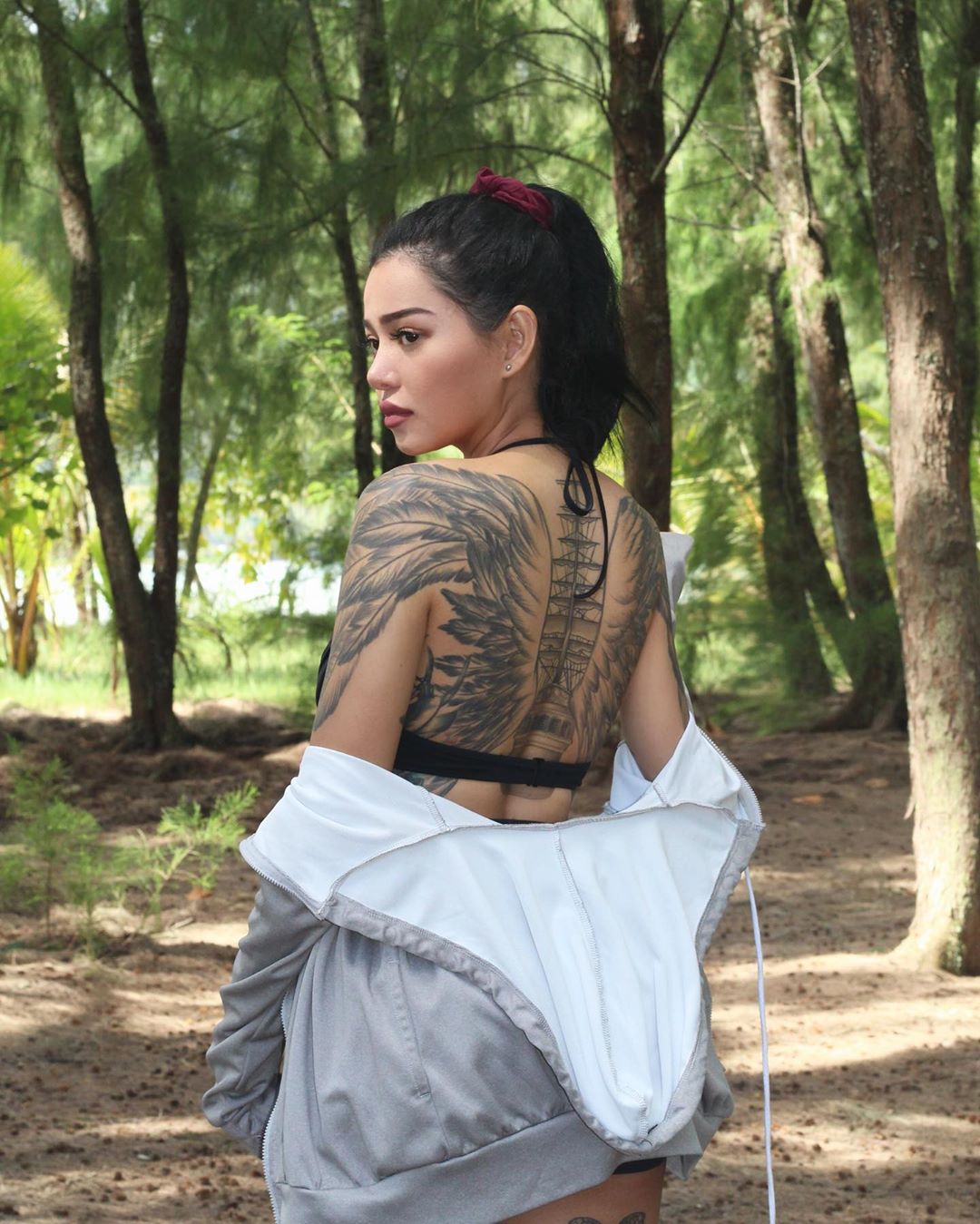 Bella Poarch tattoos: winged back tattoo from a second angle