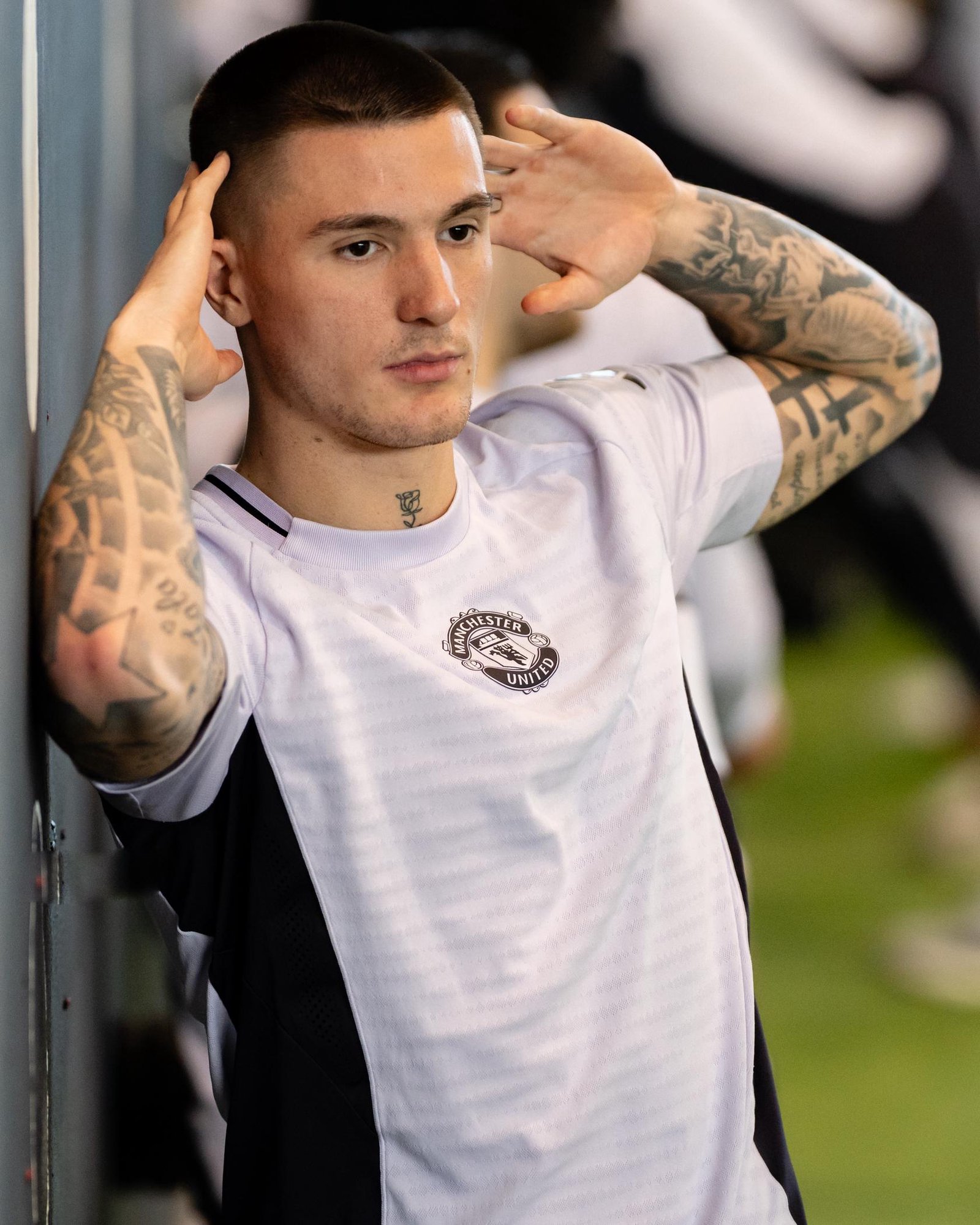 Benjamin Šeško Official training portrait showing the family name Slađana within the arm tattoo composition Benjamin Šeško tattoos: Official training portrait showing the family name Slađana within the arm tattoo composition