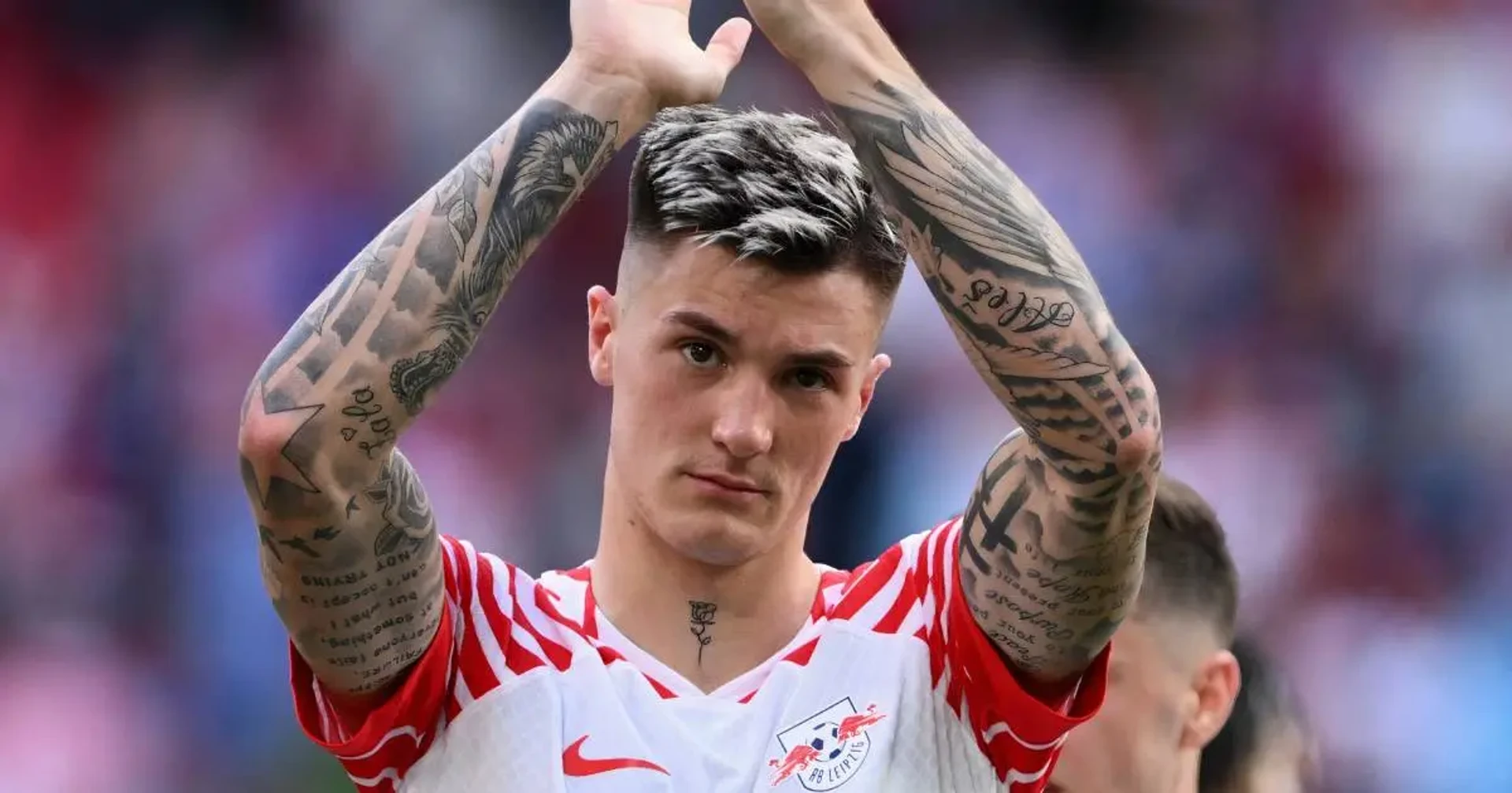 Benjamin Šeško Match photograph showing both raised tattooed arms and extensive lettering and sleeve fill Benjamin Šeško tattoos: Match photograph showing both raised tattooed arms and extensive lettering and sleeve fill