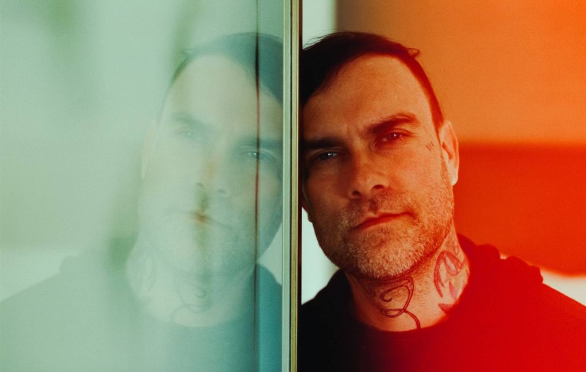 Bert McCracken tattoos: face-visible portrait with cheek and neck tattoo marks