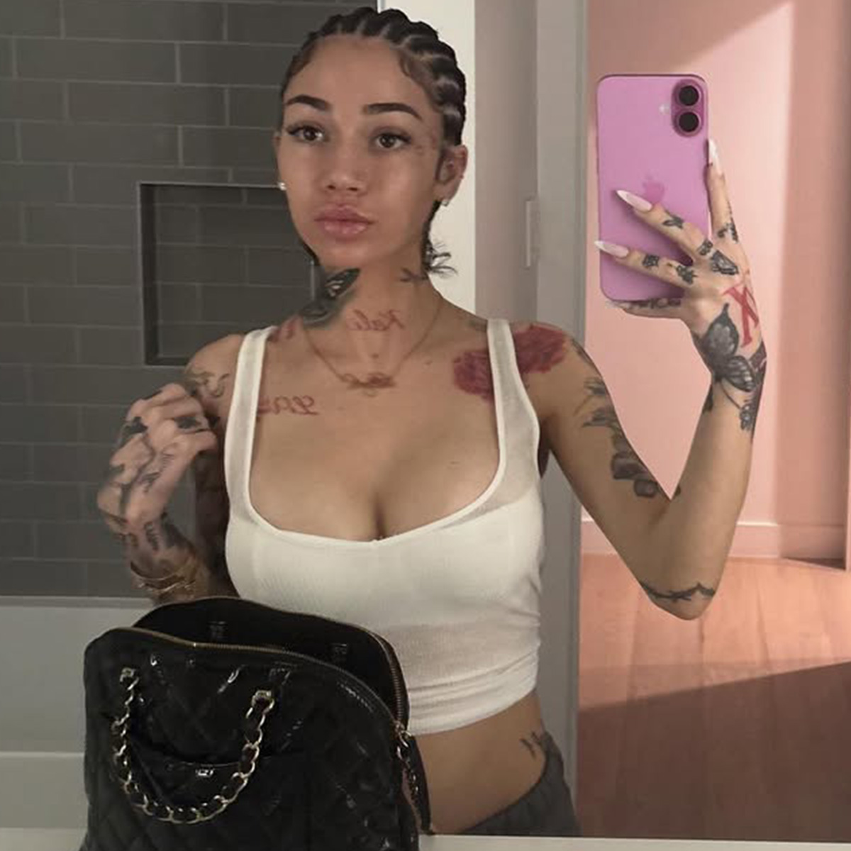 Bhad Bhabie tattoos: separate mirror photo showing the arm, neck, chest and hand ink