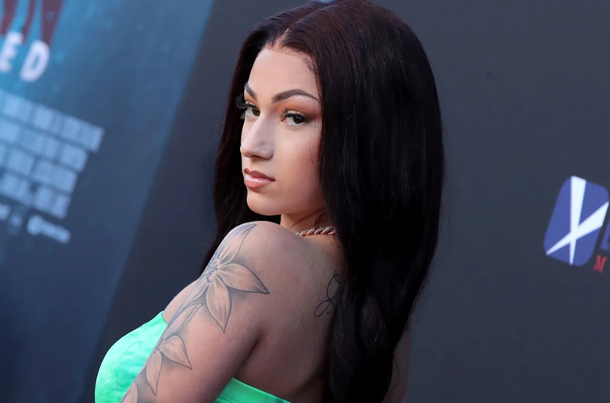 Bhad Bhabie tattoos: side view showing the large floral upper-arm tattoo and back shoulder work