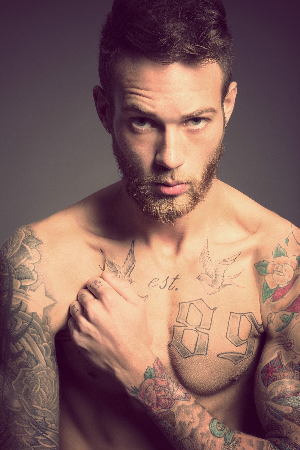Billy Huxley Outlined chest numbers, cursive est. and paired small birds Billy Huxley tattoos: Outlined chest numbers, cursive est. and paired small birds
