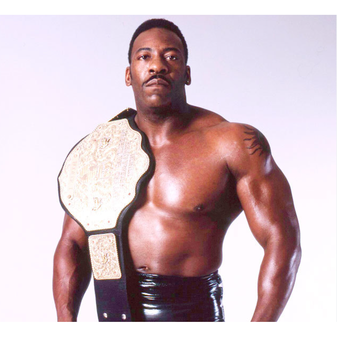 Booker T shoulder tattoo beside the championship belt
