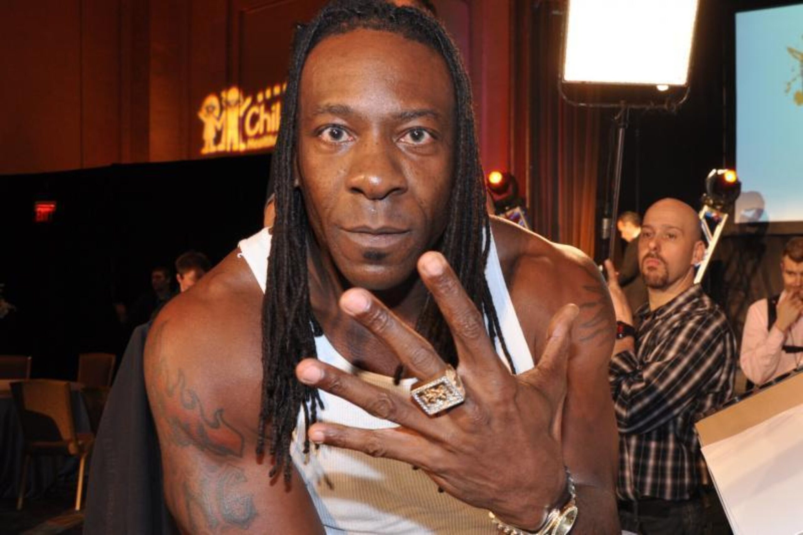 Booker T flames and shoulder tattoos at a wrestling event