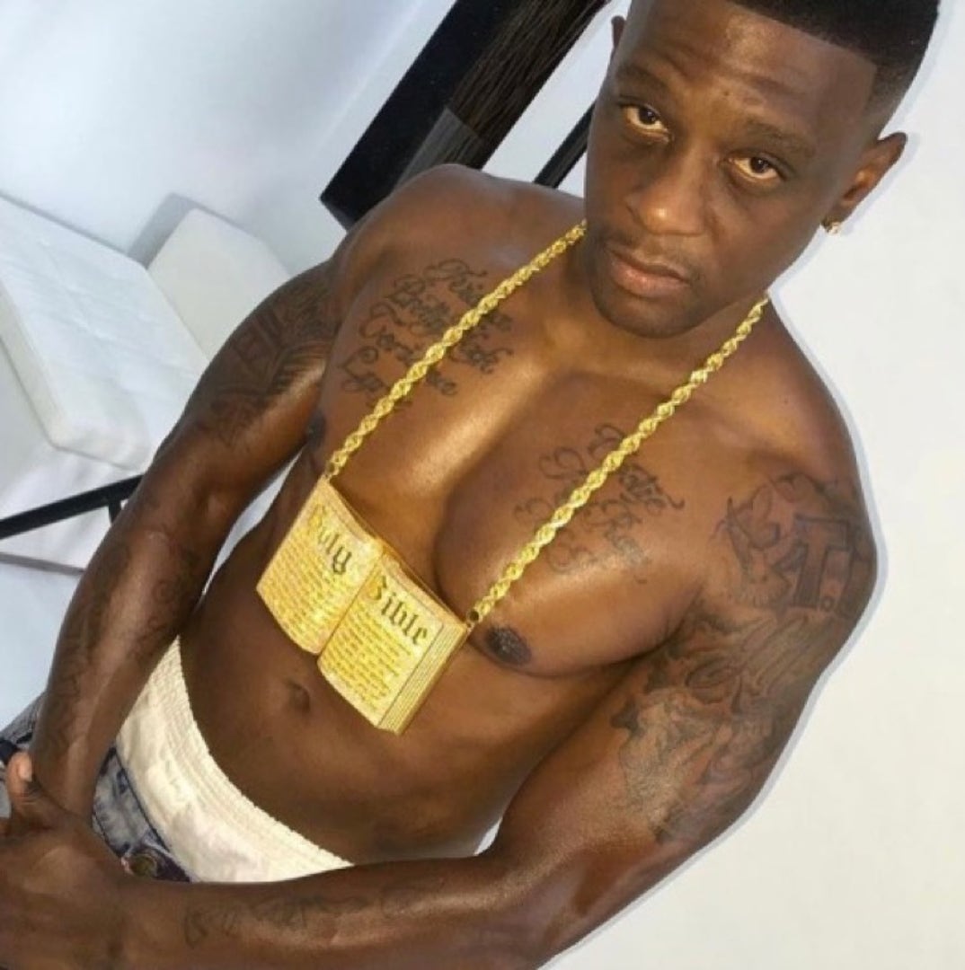 Boosie BadAzz tattoos: shirtless jewelry portrait showing dense chest and arm tattoo coverage