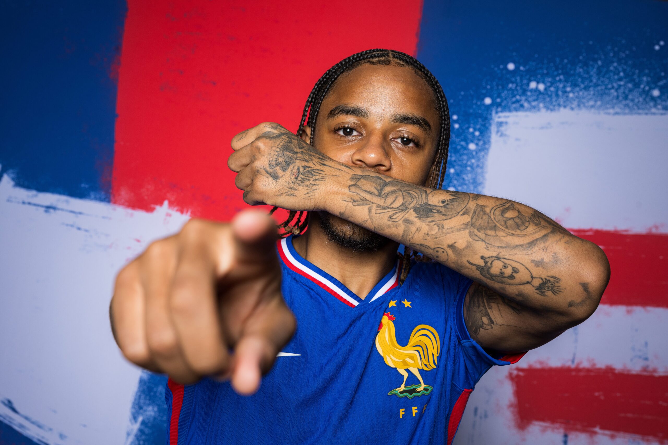 Bradley Barcola tattoos: High-resolution face-visible portrait showing the dense script and shaded tattoos on Bradley Barcola’s forearm and hand