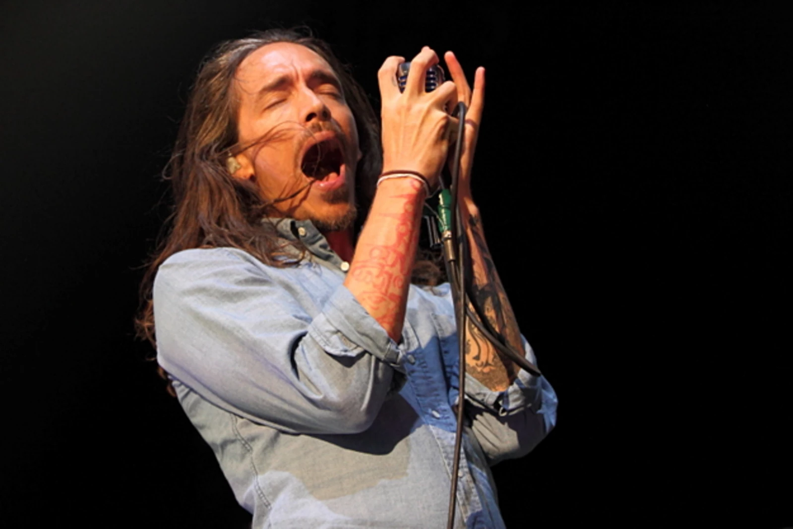 Brandon Boyd forearm tattoos during a performance