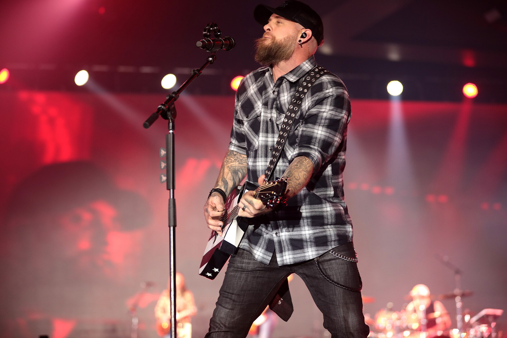 Brantley Gilbert arm tattoos while playing guitar