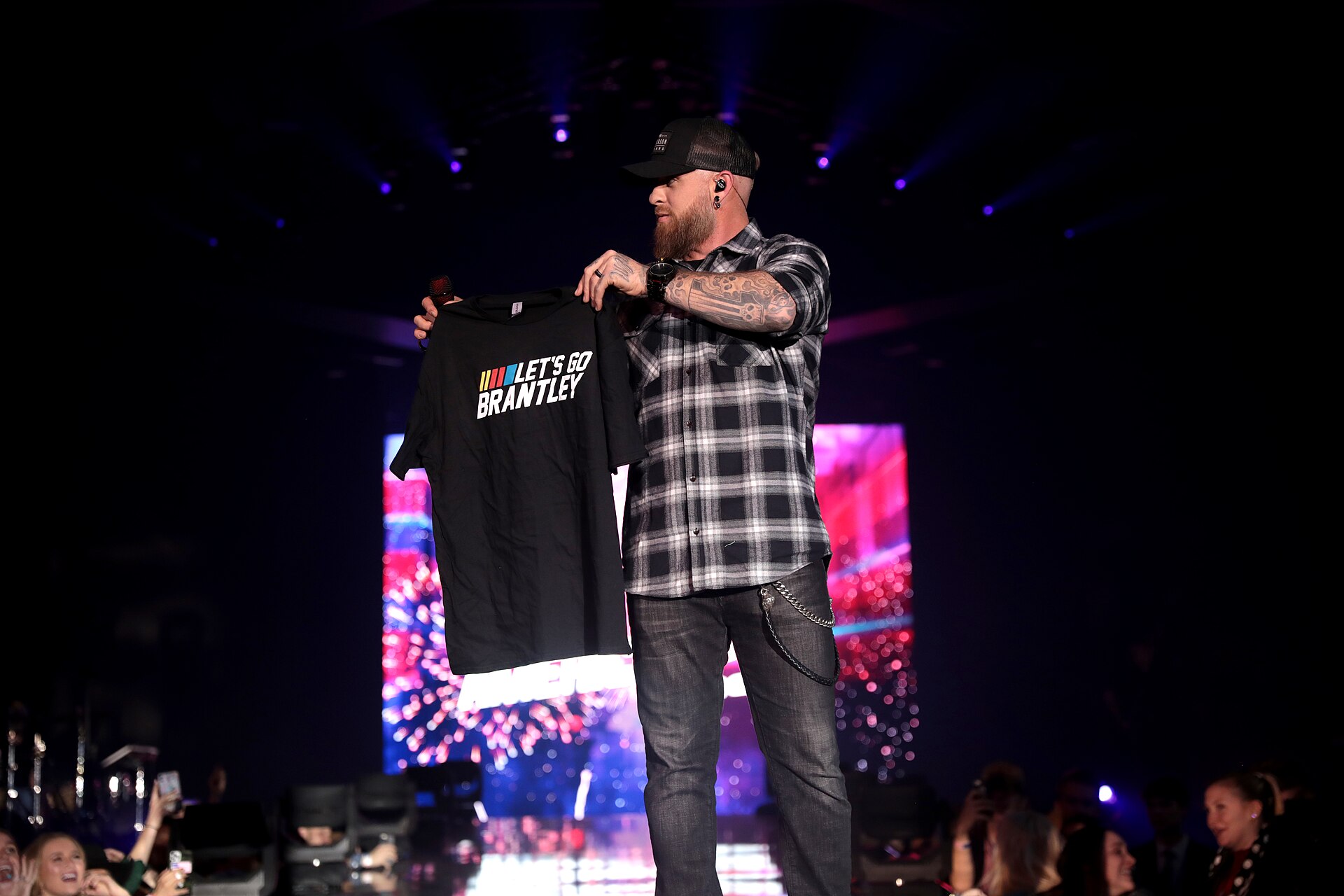 Brantley Gilbert raised forearm tattoo during a live performance