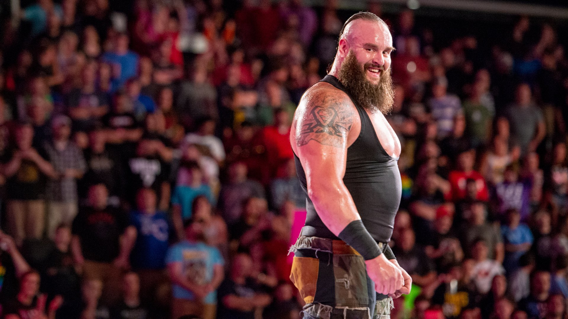 Braun Strowman tattoos: Pointed black pattern and gray shading surrounding the Superman emblem