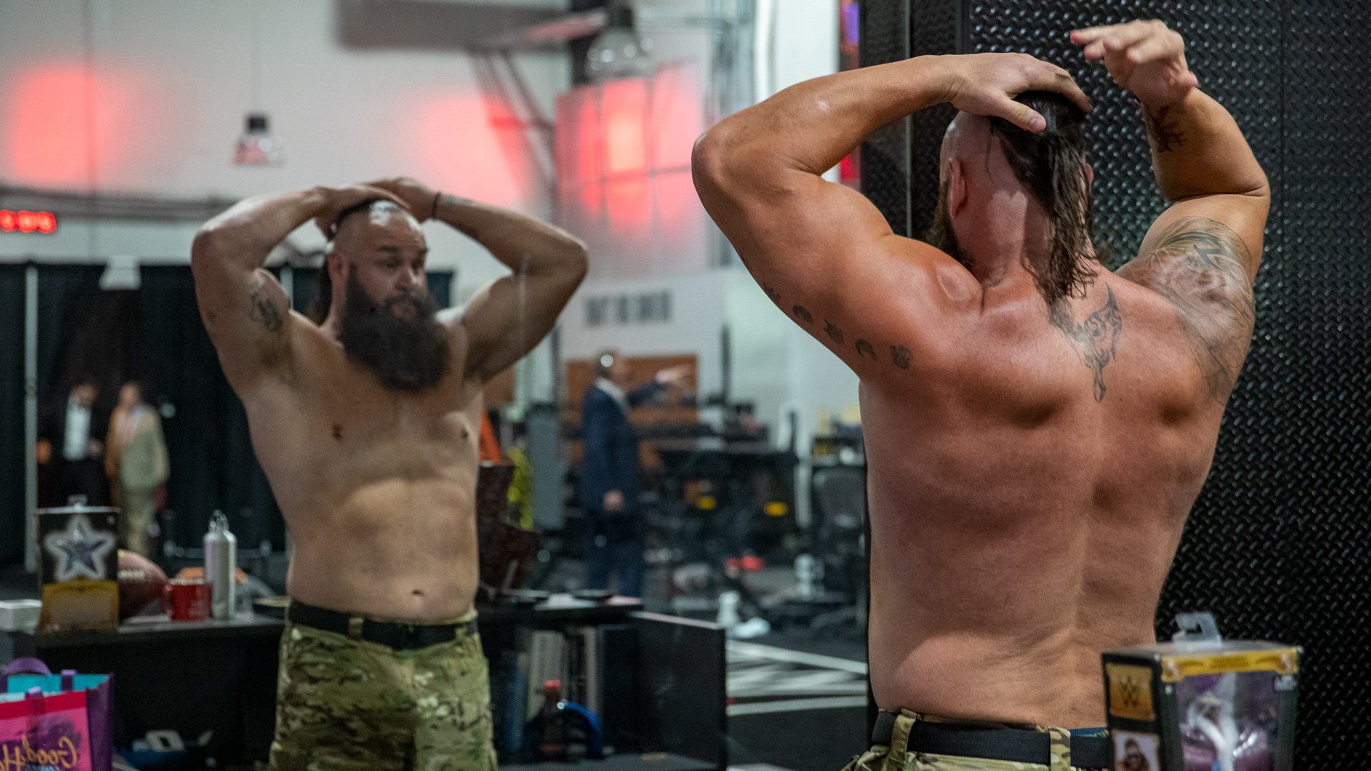 Braun Strowman tattoos: Compact dragon-shaped black design high on the back