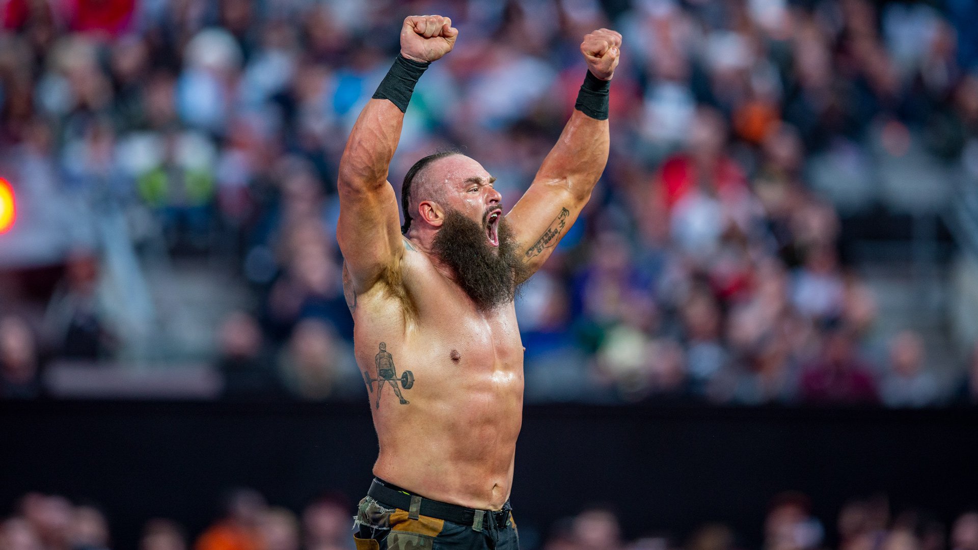 Braun Strowman tattoos: Standing weightlifter holding a barbell on the right ribs