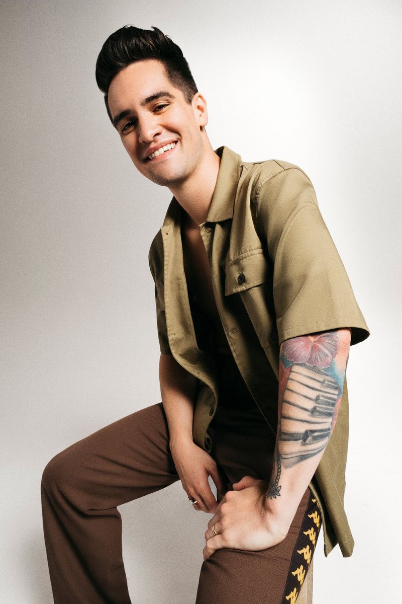 Brendon Urie tattoos: colorful piano keys and flower sleeve on the forearm