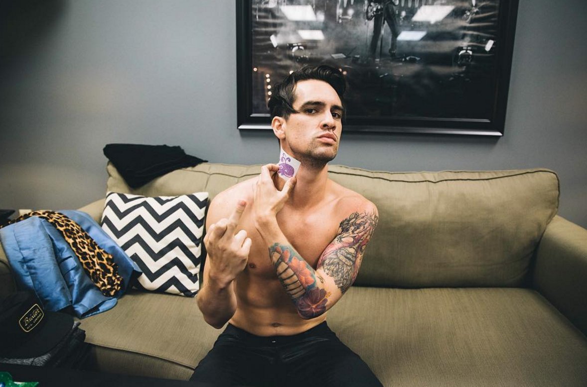 Brendon Urie tattoos: shirtless view of the full floral and portrait sleeve