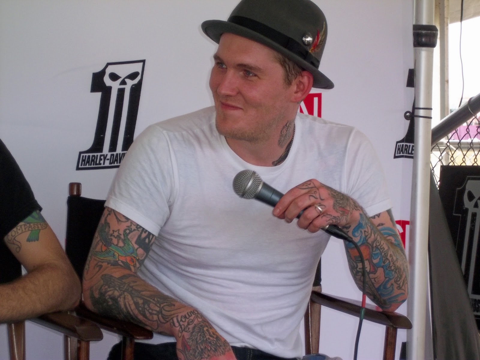 Brian Fallon tattoos: colorful arm and neck tattoos during a public interview