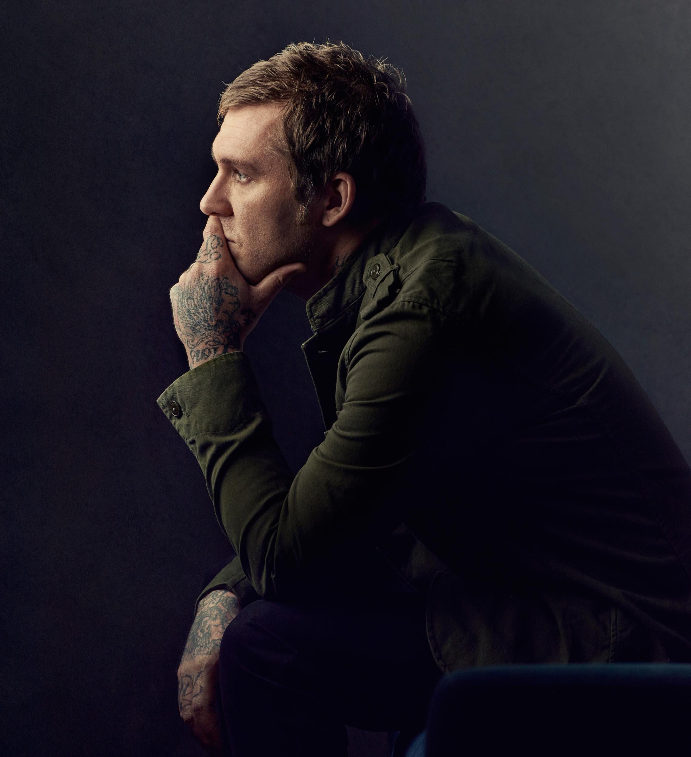 Brian Fallon tattoos: tattooed hand and forearm in a side-profile portrait