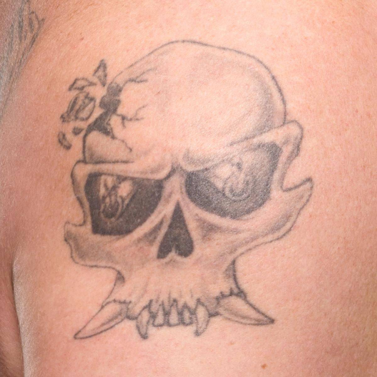 Brock Lesnar's shattered skull tattoo on his right arm