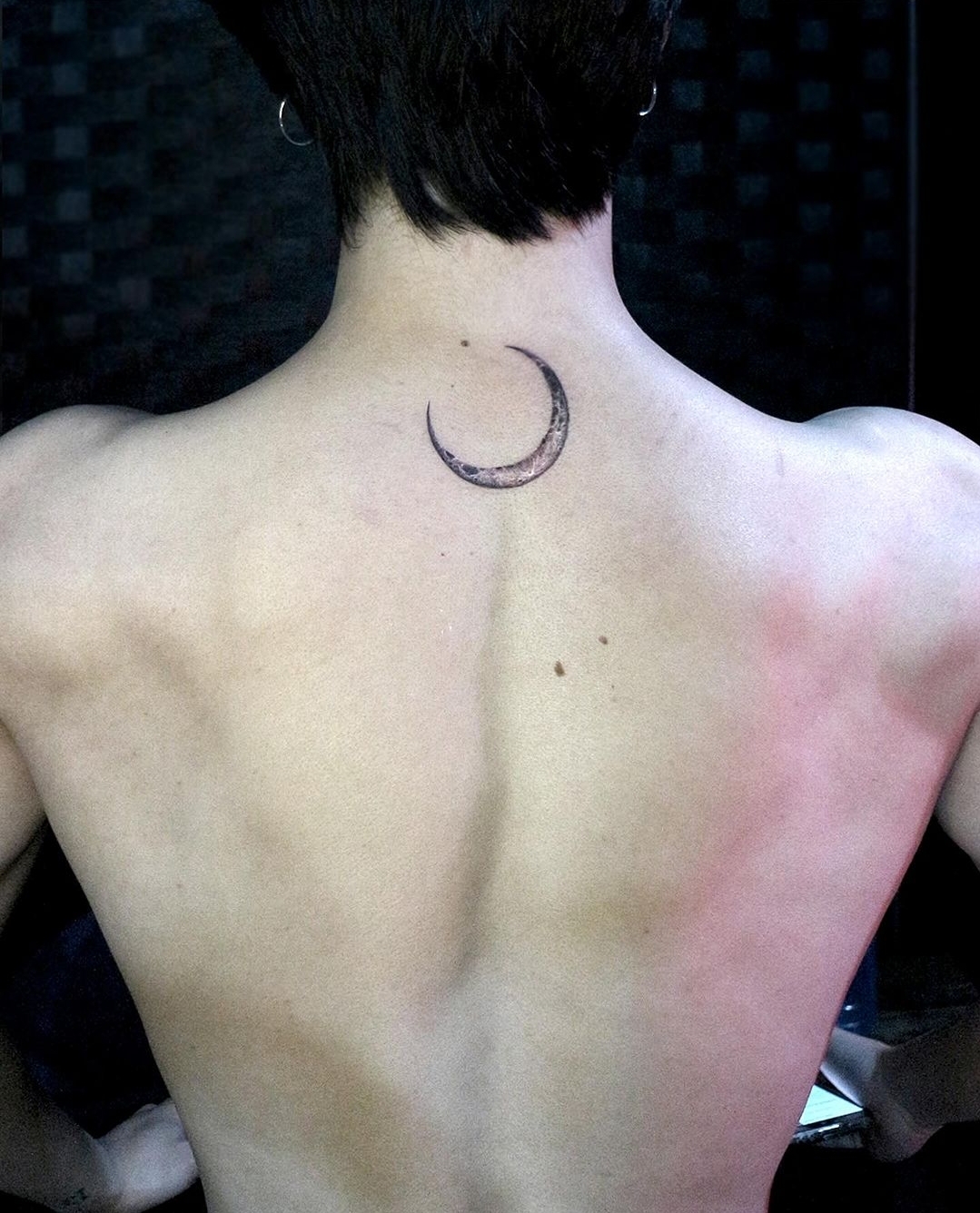 BTS Jimin tattoos: Back photograph documenting the moon tattoo placement.