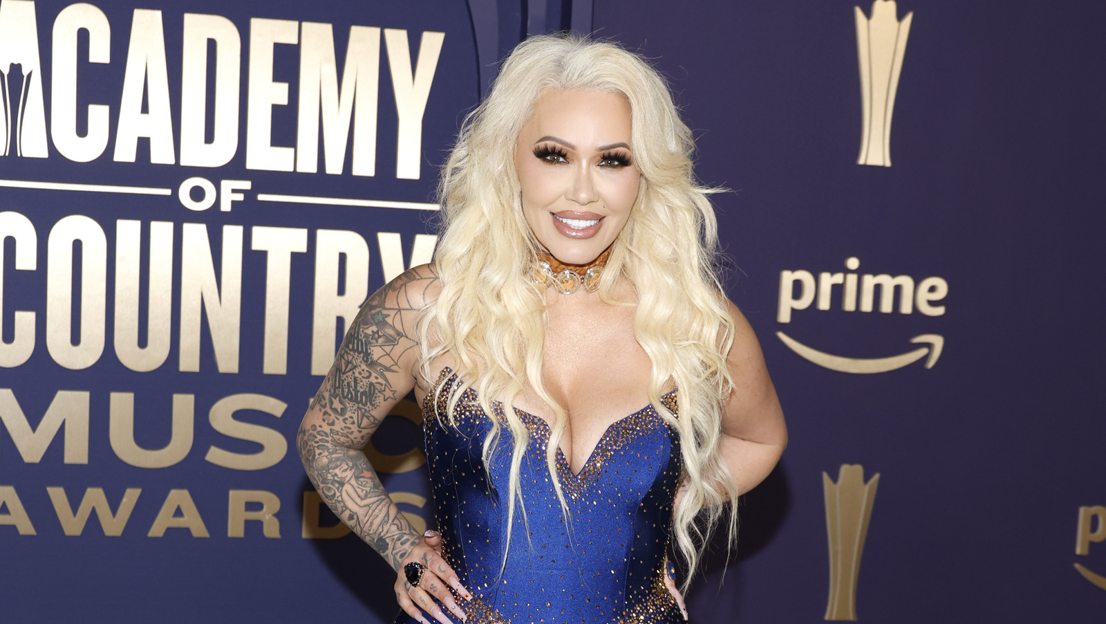 Bunnie XO at the ACM Awards with arm tattoos visible Bunnie XO tattoos: Distinct ACM portrait with face and substantial arm tattoos clearly visible; used to illustrate the sleeve's placement and overall coverage.
