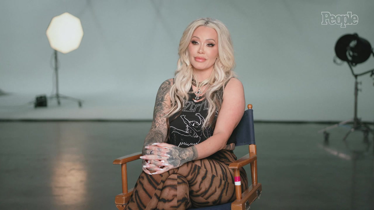 Bunnie XO seated for a People interview with her sleeve visible Bunnie XO tattoos: Distinct studio interview portrait showing Bunnie's face, sleeve and tattooed hands; supports the visible collection, not individual meanings.