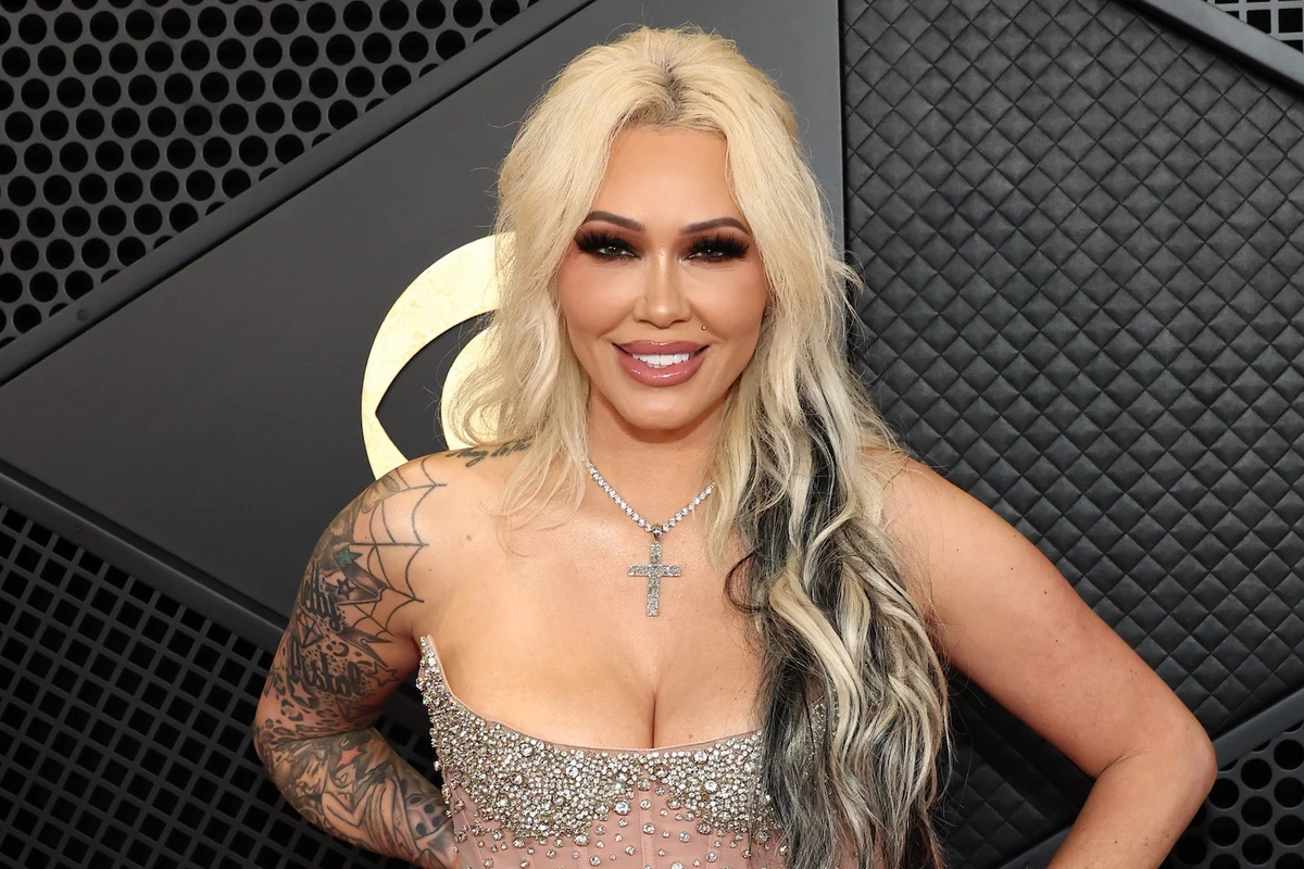 Bunnie XO at a red-carpet event with tattoos visible Bunnie XO tattoos: Separate portrait with face, shoulder and arm tattoos visible; broad tattoo coverage rather than a single-design close-up.