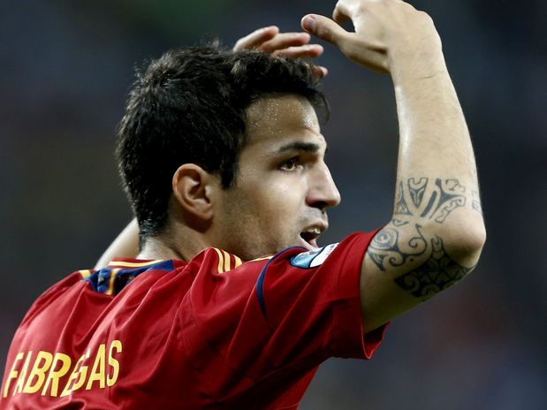Cesc Fabregas showing the bold elbow tattoo while celebrating for Spain