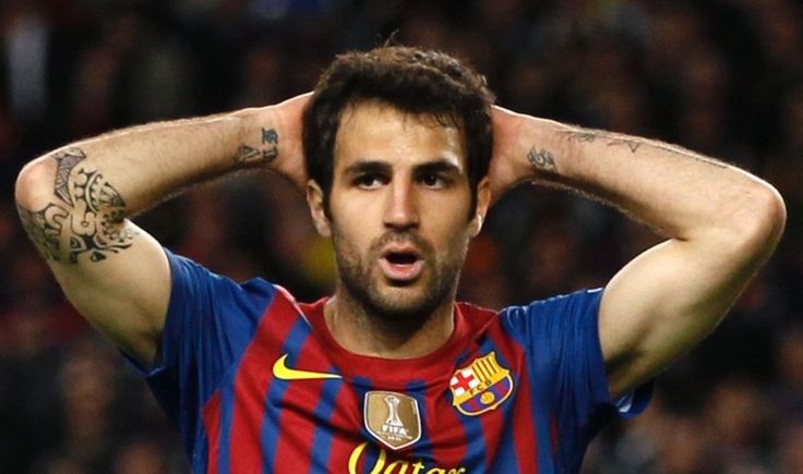 Cesc Fabregas with the large elbow tattoo visible in a Barcelona shirt