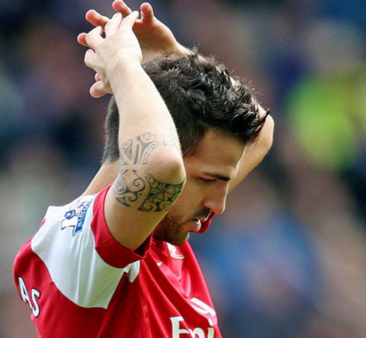 Close view of Cesc Fabregas elbow tattoo and arm lettering in an Arsenal shirt