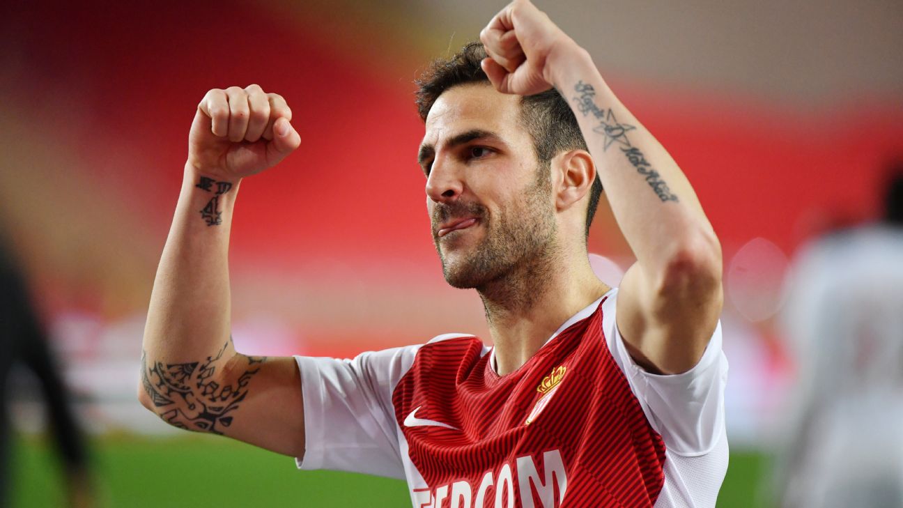 Cesc Fabregas showing script and elbow tattoos during a match celebration