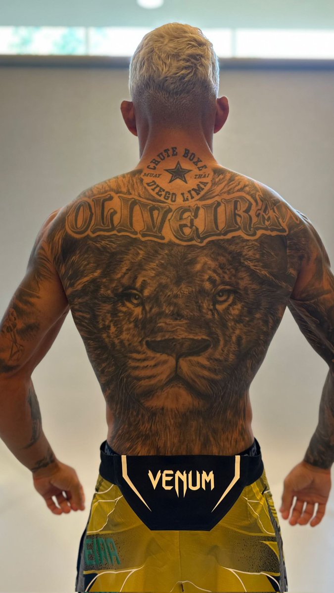 Charles Oliveira tattoos: large lion back tattoo with Oliveira lettering