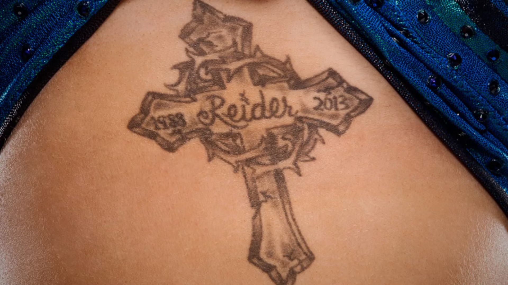 Charlotte Flair tattoos: The Reider memorial cross tattoo