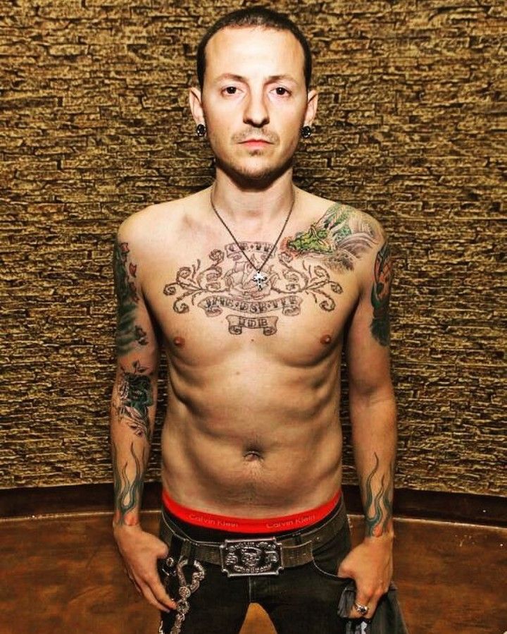Chester Bennington chest, arm, and flame tattoos