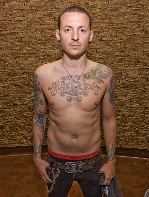 Chester Bennington chest and sleeve tattoos in a shirtless portrait