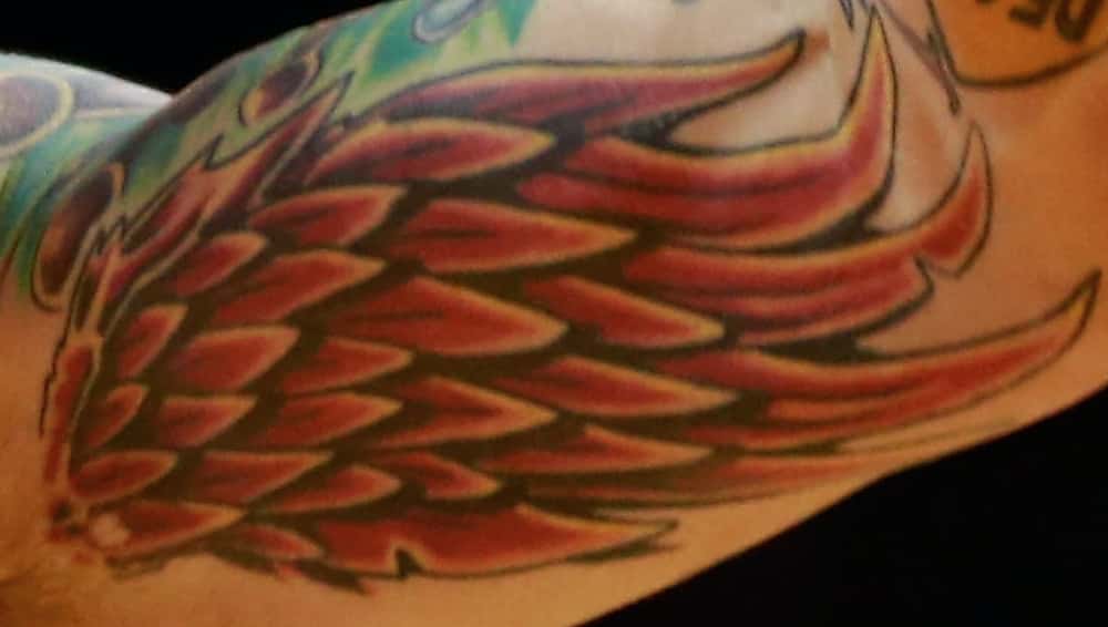Chris Andersen red wing tattoo
