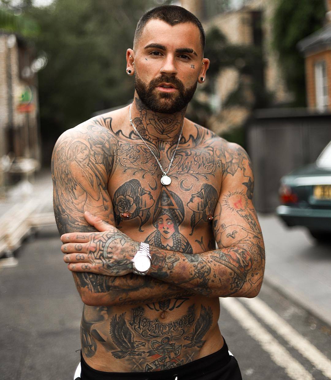 Chris Perceval tattoos: Large outlined rose centered on the front of Chris Perceval’s neck