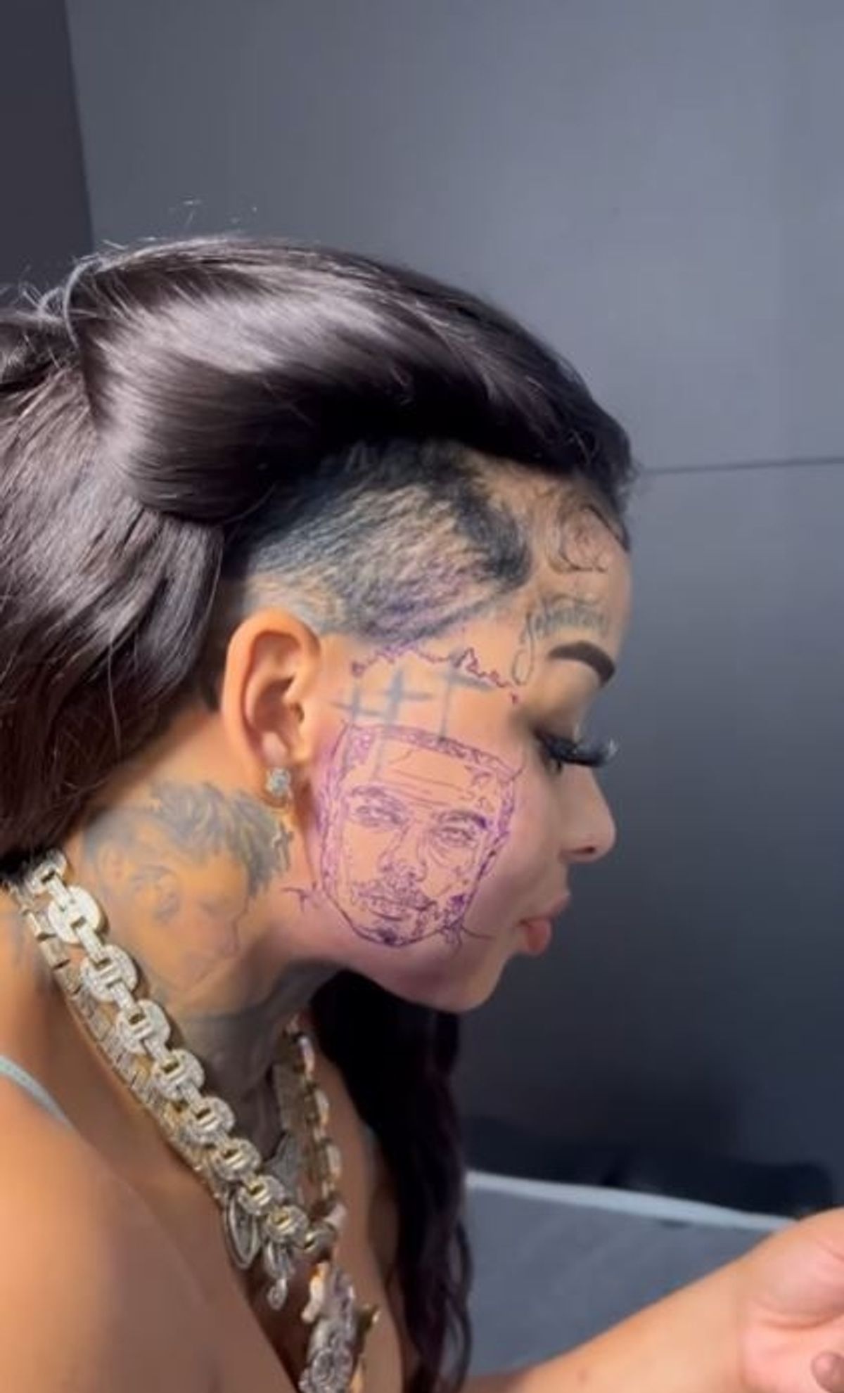 Chrisean Rock tattoos: Side-profile view of the face portrait and connected cheek and neck ink