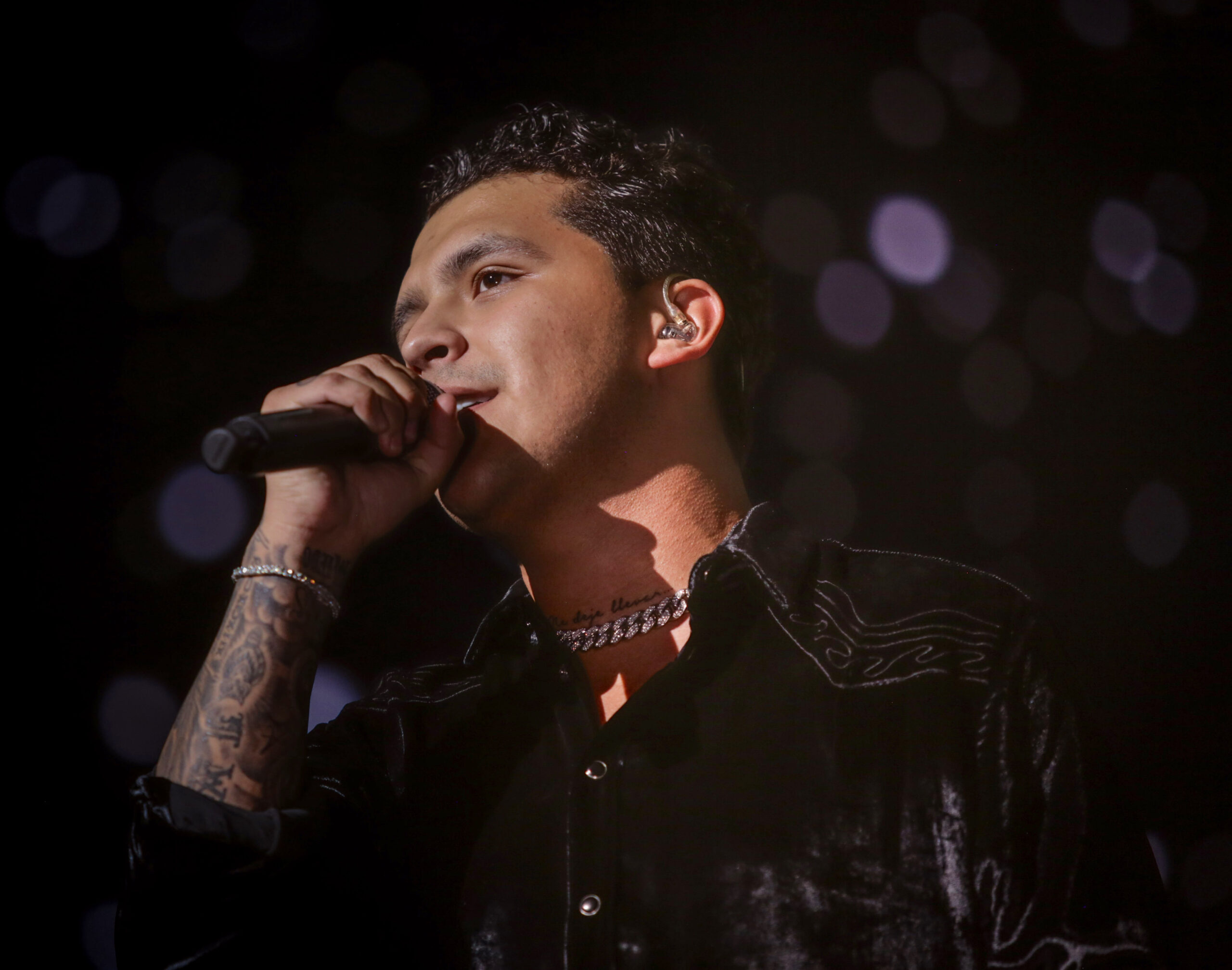 Christian Nodal tattoos: forearm sleeve and layered arm tattoos