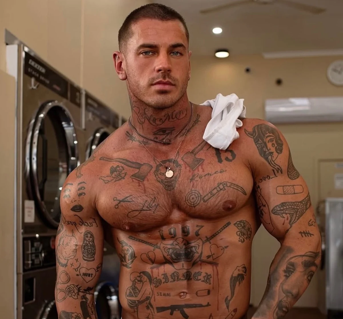 Cooper Black tattoos: Front-facing photograph showing the full chest and both arm tattoo fields