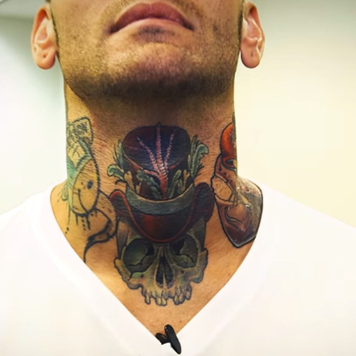 Corey Graves tattoos: clear close view of the Sacred Heart, skull and surrounding neck tattoos