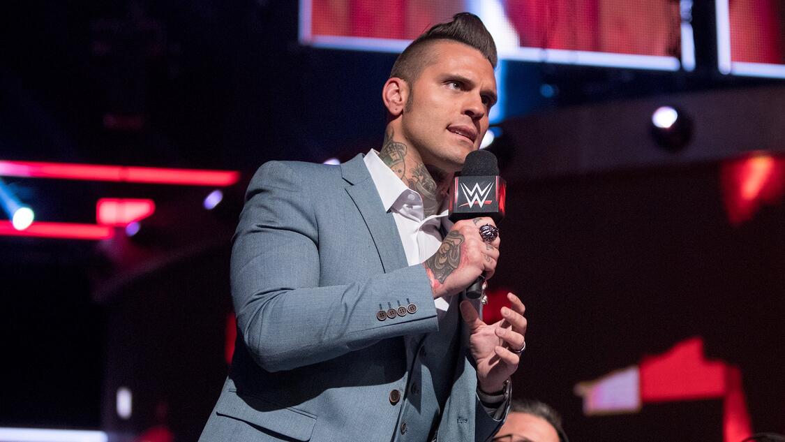 Corey Graves tattoos: separate WWE Raw photograph showing the neck tattoos and hand ink in television context