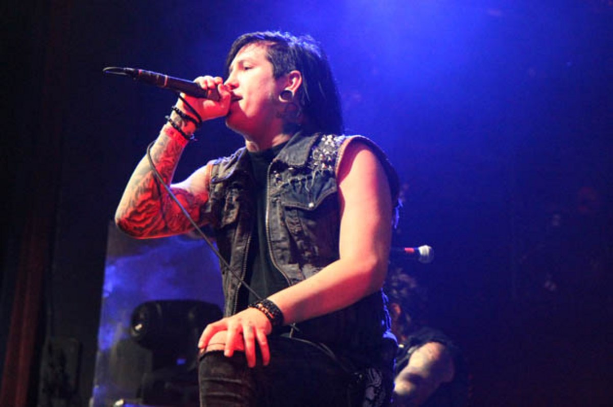 Craig Mabbitt tattoos: distinct stage photograph showing wrist, forearm and sleeve tattoos while he sings