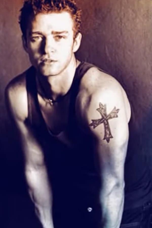 Justin Timberlake tattoos: clear upper-arm cross tattoo close-up