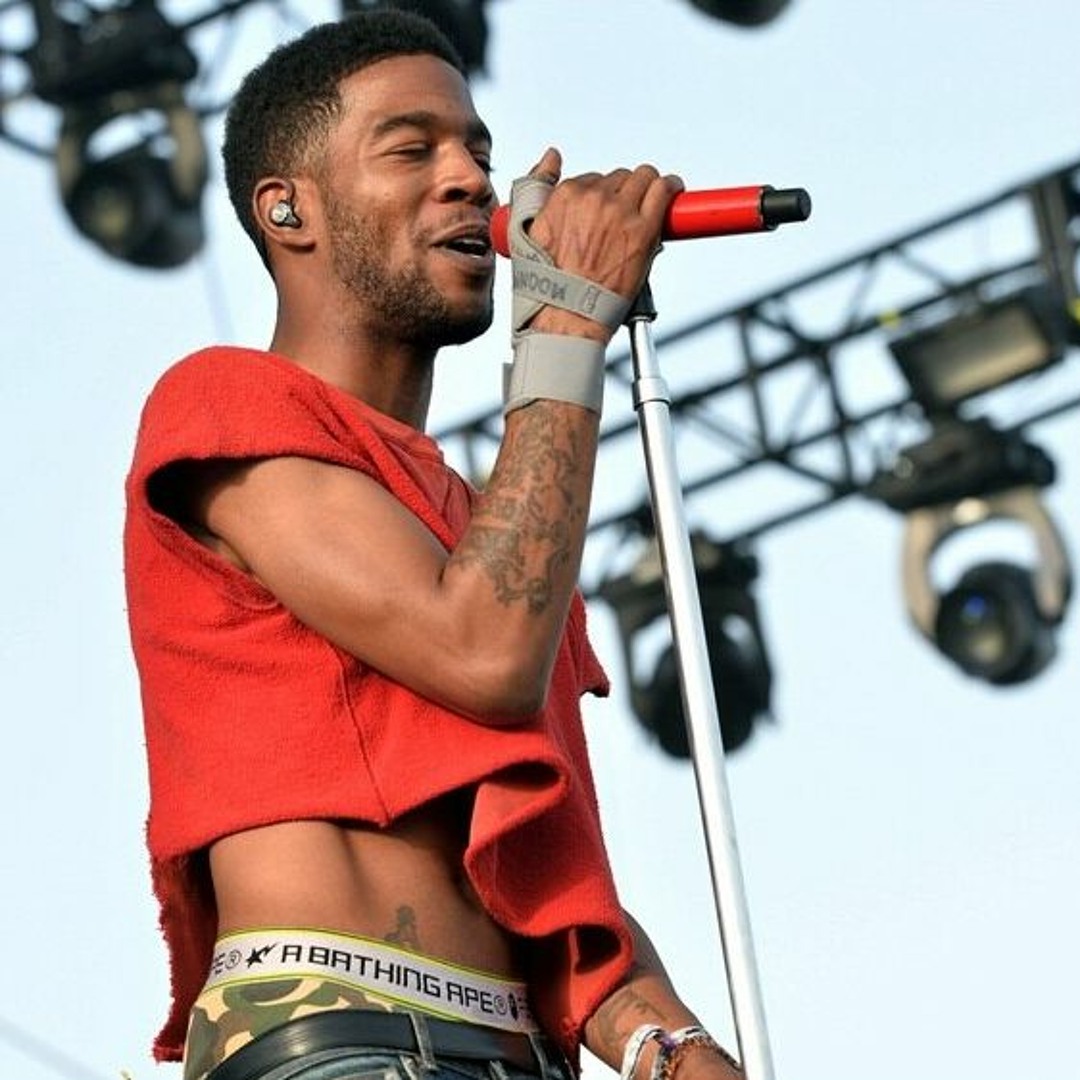 Kid Cudi performing with visible arm tattoo