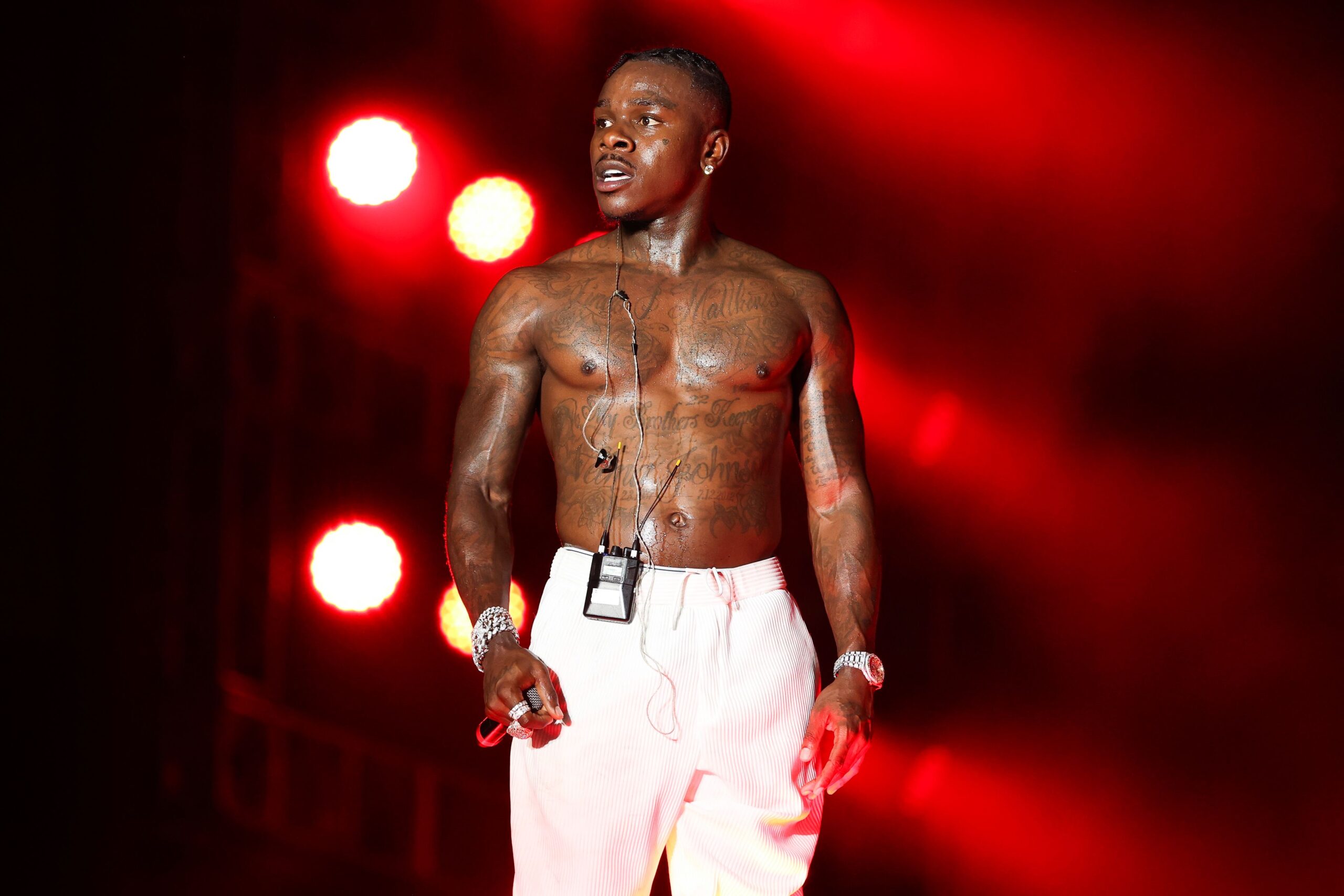 DaBaby tattoos under red stage lights