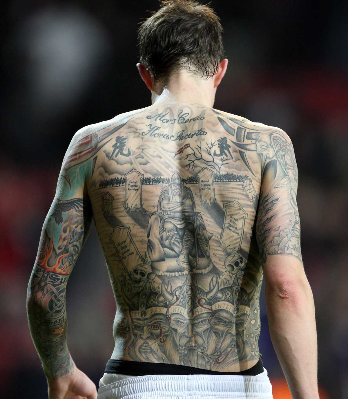 Daniel Agger tattoos: detailed close-up of Daniel Agger's Mors Certa Hora Incerta lettering and Viking back scene