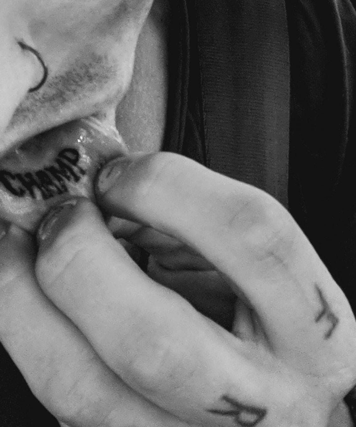 Darby Allin tattoos: clean close-up of the Champ lettering inside Darby's lower lip